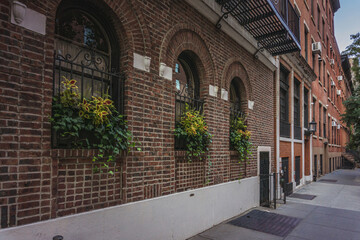 Fototapeta na wymiar Brick wall facade of apartment building on residential block of East Village in Manhattan