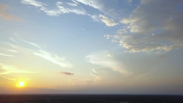 Drone sun and clouds panoramic left Raleigh North Carolina at sunset