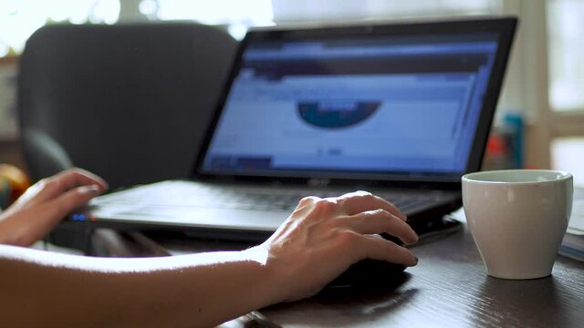 Woman work on home office, female freelancer work from home. Working at home during pandemic. Typing on keyboard, working on laptop, using a mouse. Stay home, save lives. Close up.Scene C.