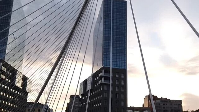 Walkig througt the Calatrava&acute;s bridge in Bilbao during the sunse