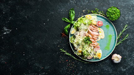 Caesar salad with chicken. Vegetable salad with chicken fillet. Top view. Rustic style.