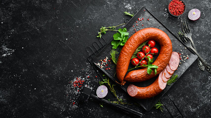 Smoked sausage ring with spices and herbs. Top view. Free space for text.