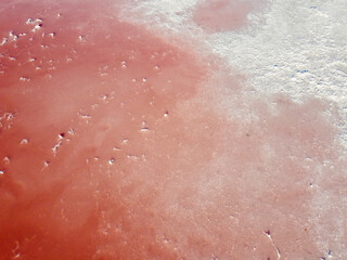 Fototapeta premium Pink water and salt on a pink lake in Spain.