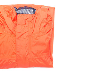 Folded orange zipper windbreaker jacket, rain proof and waterproof hiking Gore-Tex jacket hoodie....