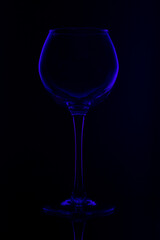 Blue wine glass. Wine glass on a black background.