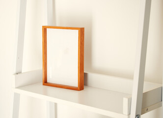 blank decorative picture frame on a clean shelf