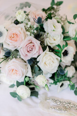 Elegant wedding bouquet with pink, peach, and white roses