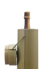A champagne bottle in a round gift box isolated on white.