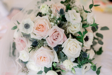 Beautiful neutral color floral wedding bouquet with white and pink roses