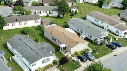 Aerial of mobile homes, trailer park, housing tightly compact, aerial drone view, establishing shot of residences in United States of America, USA during summer, low-income manufactured homes