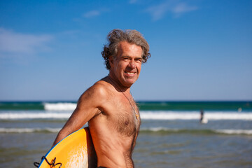 adult surfer practicing surfing on the basque coast, spain