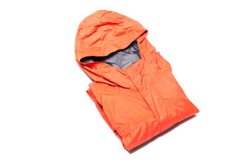 Folded orange zipper windbreaker jacket, rain proof and waterproof hiking Gore-Tex jacket hoodie....