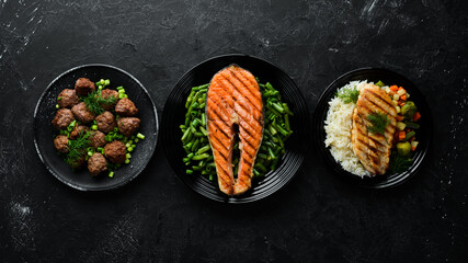 A set of dishes. Fish steak, chicken fillet, meat balls. Flat lay. Top view. Free copy space.