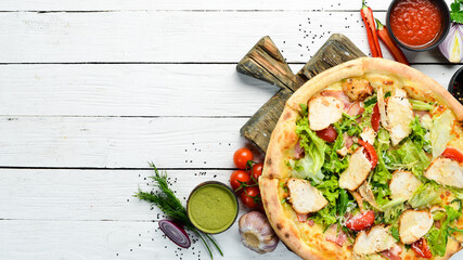 Pizza Caesar. Pizza with chicken, cheese and lettuce. Top view. Free space for your text.