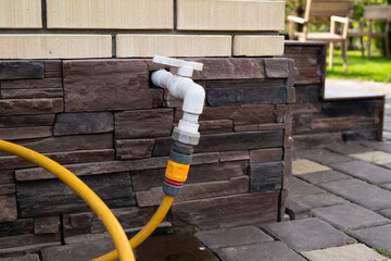 Water pipe and water tap on the brick wall