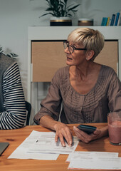 Senior woman doing finances at home stock photo