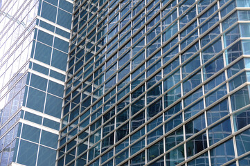 Fototapeta na wymiar Skyscraper facade with glass facade and reflections.