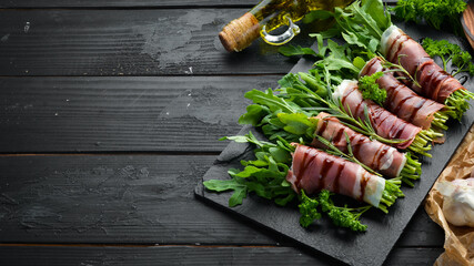 Prosciutto with arugula. Traditional Italian appetizer. Top view. Free copy space.