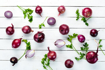 Purple fresh onion on white wooden background. Top view. Free copy space.