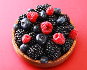 Bowl of fresh fruit. Blackberries,raspberries,blueberries on a bowl. Healthy breakfast.