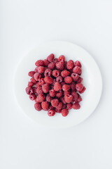 Red raspberry berries close-up on a white background. Healthy food, natural vitamins. Fresh berries