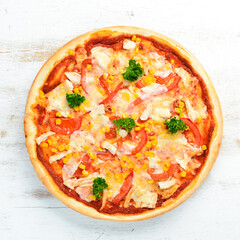 Homemade pizza with chicken, tomatoes and corn. Top view. free space for your text. Rustic style.
