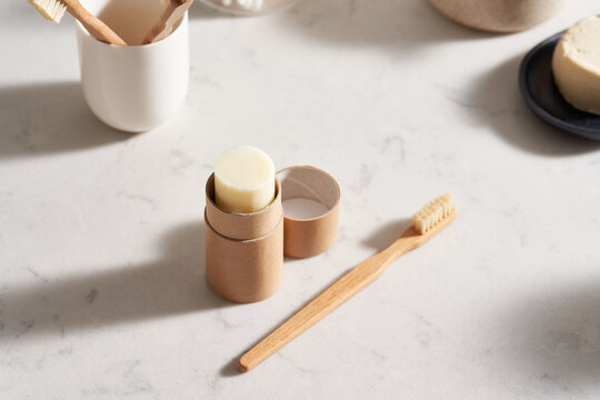 Open solid toothpaste near toothbrush