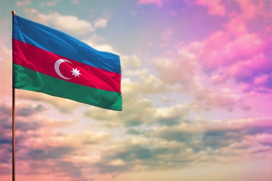 Fluttering Azerbaijan flag mockup with the space for your content on colorful cloudy sky background.
