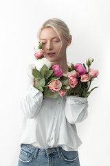 Charming young woman showing her arms with flowers in sleeves