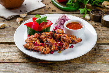Kebab of pork on old wooden table