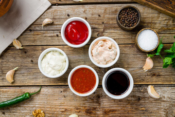 assorted sauces top view on old wooden table