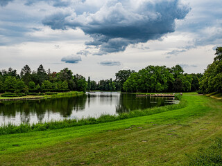 Obraz premium Gartenreich, Wörlitz, Germany, 27 July 2020. Idyllic landscape of formal gardens, trees, lakes and lawns in the Eastern part of Germany. Unesco world heritage site.