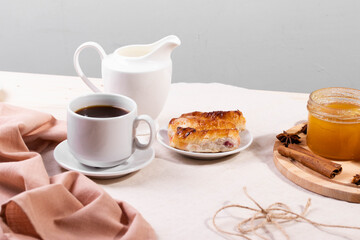 a ceramic cup of coffee and honey treats