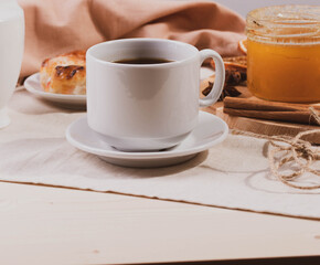 a ceramic cup of coffee and honey treats