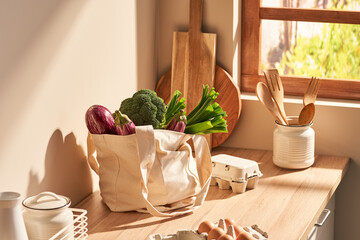 Cotton bag with groceries in modern kitchen