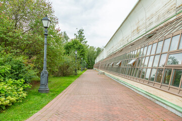 A path for pedestrians to walk in a modern green city park in the summer daytime