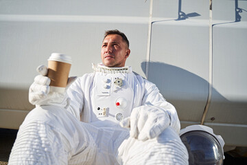 Attractive male astronaut drinking hot coffee © Yakobchuk Olena