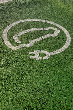 Electric car parking and charging station sign on asphalt