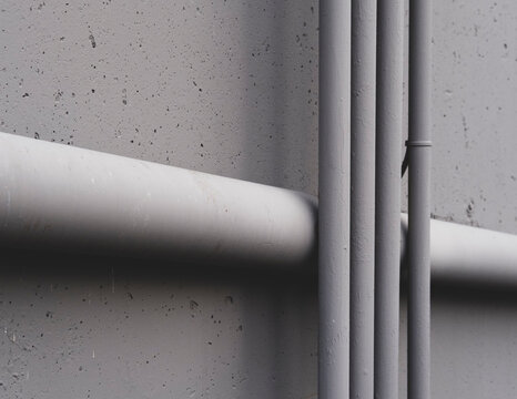 Electrical piping and drainage pipe on building wall