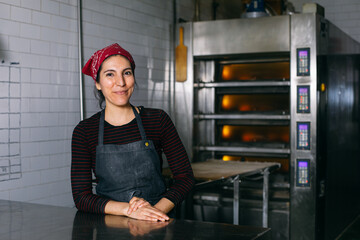 Happy female baker looking at camera