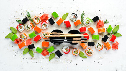 Sushi set on white wooden background. Set of colored sushi with seafood. Traditional Japanese cuisine.