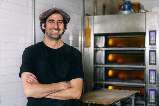 Cheerful bakery owner looking at camera