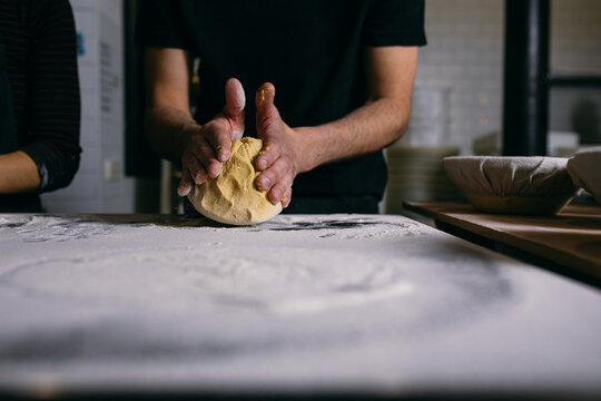 Baker kneading yellow dough