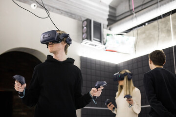 Friends enjoying vr gaming in an indoor arcade