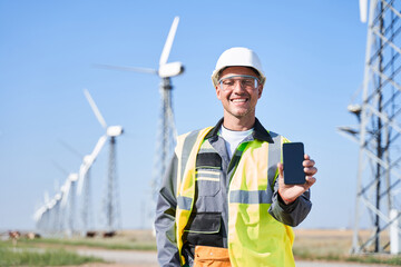 Alternative power concept with worker on windmill background