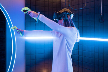 Woman enjoying vr gaming in an indoor arcade