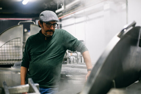 Man watching brewing process on factory