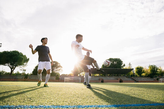 Football players playing football on field