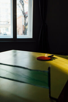Ping Pong Racket On A Yellow Table Tennis Desk