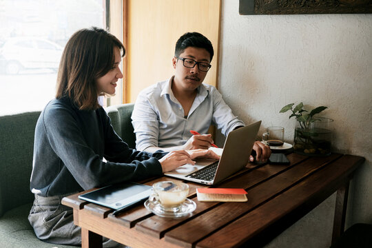 Caucasian woman and asian man coworking